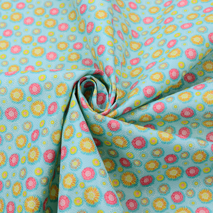 Light blue fabric featuring an all-over repeating pattern of vibrant pink and gold floral motifs interspersed with small yellow dotted accents.