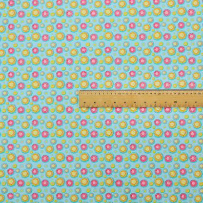 Light blue fabric featuring an all-over repeating pattern of vibrant pink and gold floral motifs interspersed with small yellow dotted accents.