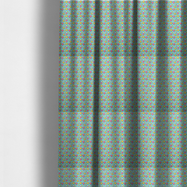 The fabric used to create these made-to-measure curtains is a light blue fabric featuring an all-over repeating pattern of vibrant pink and gold floral motifs interspersed with small yellow dotted accents.