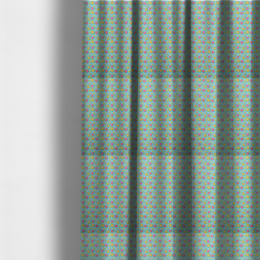 The fabric used to create these made-to-measure curtains is a light blue fabric featuring an all-over repeating pattern of vibrant pink and gold floral motifs interspersed with small yellow dotted accents.