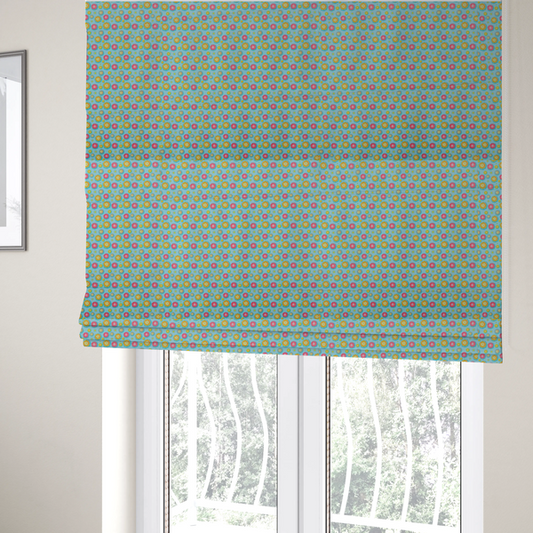 The fabric used to create these Roman blinds is a light blue fabric featuring an all-over repeating pattern of vibrant pink and gold floral motifs interspersed with small yellow dotted accents.