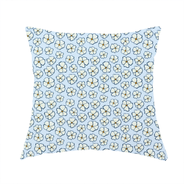 The fabric used to create this handmade cushion is a light blue fabric featuring a dense, repeating pattern of small white flowers with yellow centres and dark outlines.