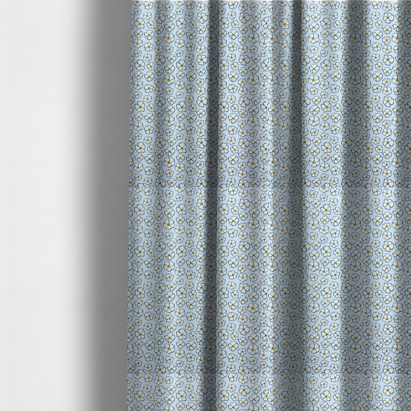 The fabric used to create these made-to-measure curtains is a light blue fabric featuring a dense, repeating pattern of small white flowers with yellow centres and dark outlines.