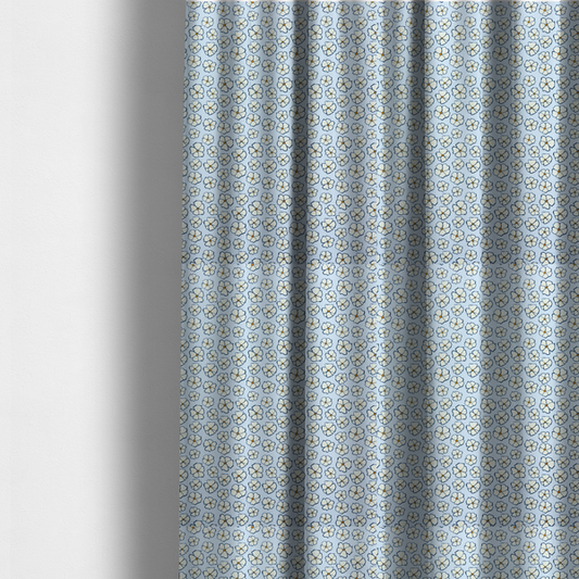 The fabric used to create these made-to-measure curtains is a light blue fabric featuring a dense, repeating pattern of small white flowers with yellow centres and dark outlines.