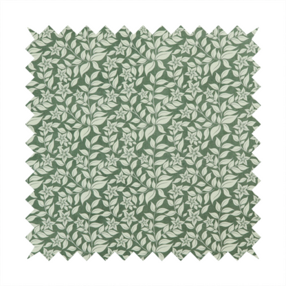 A green fabric featuring an intricate, repeating botanical pattern of trailing vines, leaves, and small white flowers.
