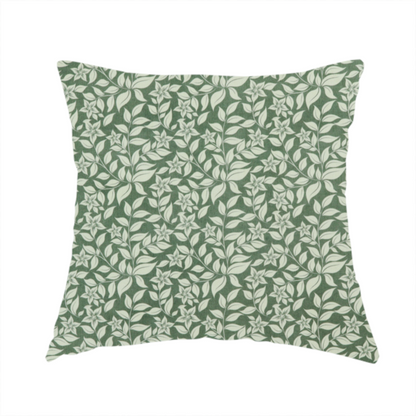 The fabric used to create this handmade cushion is a green fabric featuring an intricate, repeating botanical pattern of trailing vines, leaves, and small white flowers.