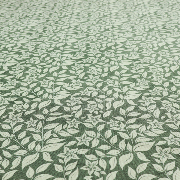 A green fabric featuring an intricate, repeating botanical pattern of trailing vines, leaves, and small white flowers.