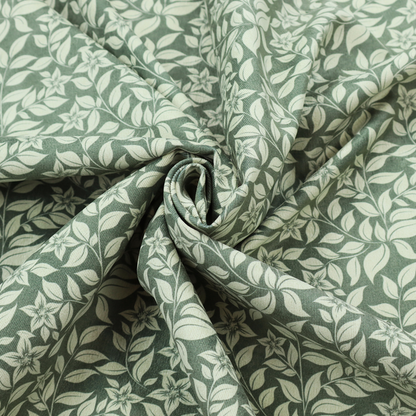 A green fabric featuring an intricate, repeating botanical pattern of trailing vines, leaves, and small white flowers.