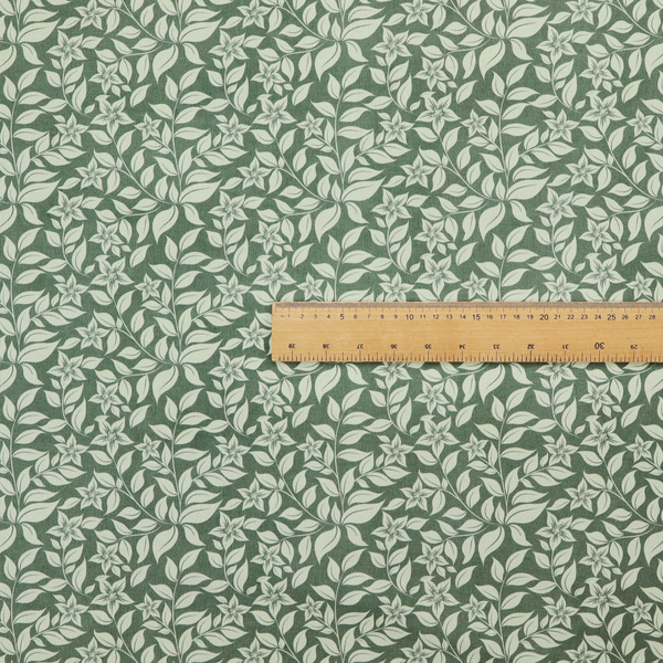 A green fabric featuring an intricate, repeating botanical pattern of trailing vines, leaves, and small white flowers.