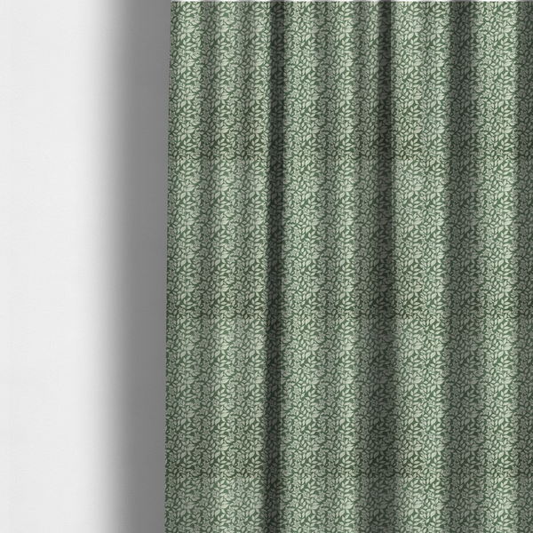 The fabric used to create these made-to-measure curtains is a green fabric featuring an intricate, repeating botanical pattern of trailing vines, leaves, and small white flowers.
