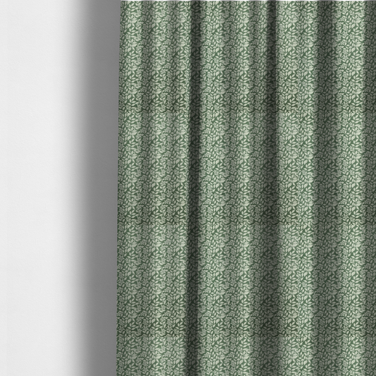 The fabric used to create these made-to-measure curtains is a green fabric featuring an intricate, repeating botanical pattern of trailing vines, leaves, and small white flowers.