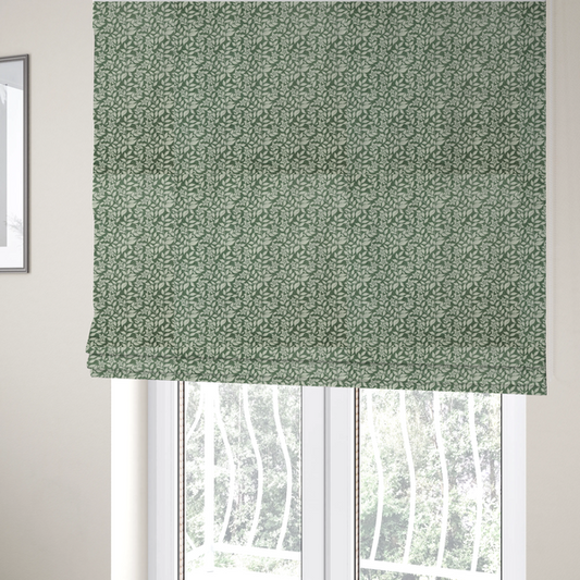 The fabric used to create these Roman blinds is a green fabric featuring an intricate, repeating botanical pattern of trailing vines, leaves, and small white flowers.