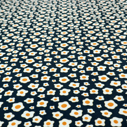 A dark navy blue fabric featuring a dense, repeating pattern of small fried egg motifs with white whites and yellow yolks.