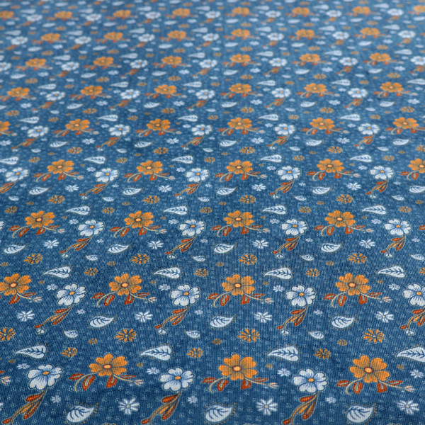 A royal blue fabric featuring a detailed, repeating pattern of orange and white flowers, small leaves, and sprigs