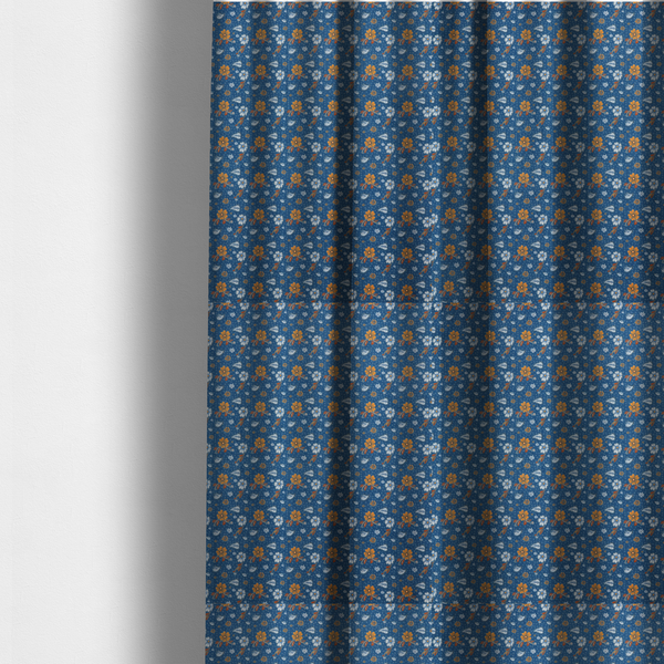 The fabric used to create these made-to-measure curtains is a royal blue fabric featuring a detailed, repeating pattern of orange and white flowers, small leaves, and sprigs