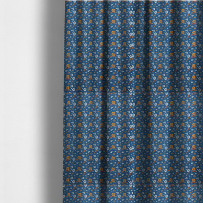 The fabric used to create these made-to-measure curtains is a royal blue fabric featuring a detailed, repeating pattern of orange and white flowers, small leaves, and sprigs