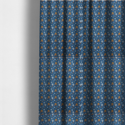 The fabric used to create these made-to-measure curtains is a royal blue fabric featuring a detailed, repeating pattern of orange and white flowers, small leaves, and sprigs