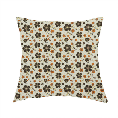 The fabric used to create this handmade cushion is a light cream fabric featuring a repeating retro pattern of dark brown and orange flowers with scrolling vines.