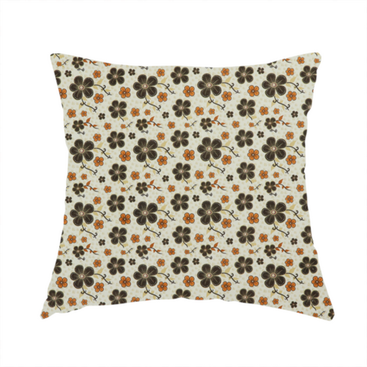 The fabric used to create this handmade cushion is a light cream fabric featuring a repeating retro pattern of dark brown and orange flowers with scrolling vines.