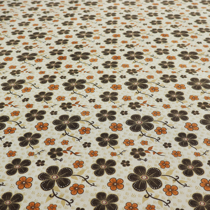 A light cream fabric featuring a repeating retro pattern of dark brown and orange flowers with scrolling vines.