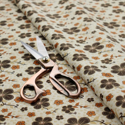 A light cream fabric featuring a repeating retro pattern of dark brown and orange flowers with scrolling vines.