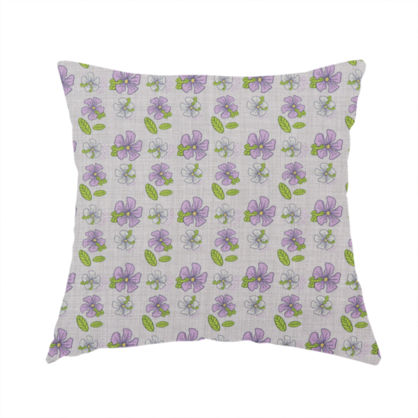 The fabric used to create this handmade cushion is a light grey-purple fabric featuring a repeating pattern of purple and white flowers with green leaves.