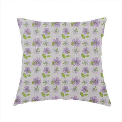 The fabric used to create this handmade cushion is a light grey-purple fabric featuring a repeating pattern of purple and white flowers with green leaves.