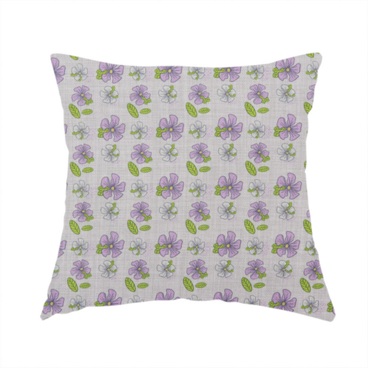 The fabric used to create this handmade cushion is a light grey-purple fabric featuring a repeating pattern of purple and white flowers with green leaves.