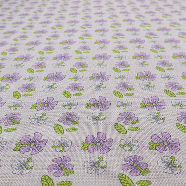 A light grey-purple fabric featuring a repeating pattern of purple and white flowers with green leaves.