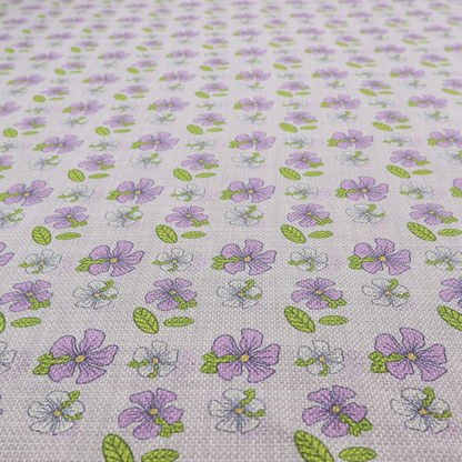 A light grey-purple fabric featuring a repeating pattern of purple and white flowers with green leaves.