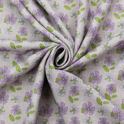 A light grey-purple fabric featuring a repeating pattern of purple and white flowers with green leaves.