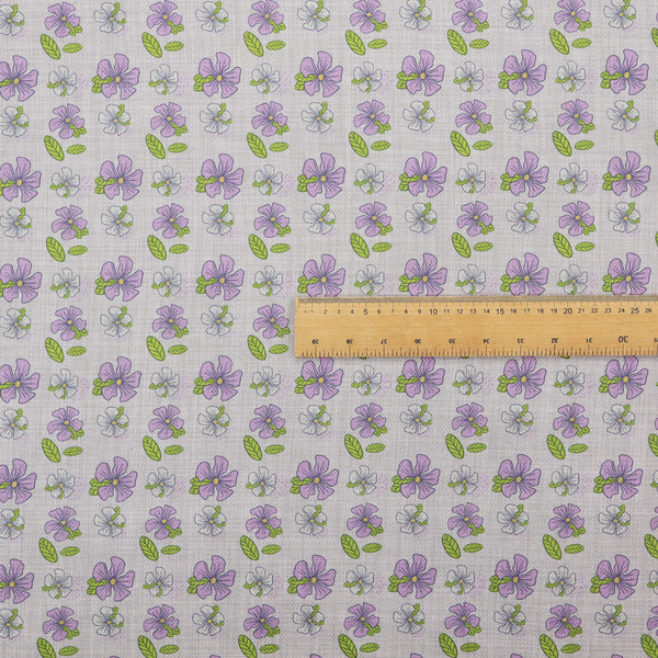 A light grey-purple fabric featuring a repeating pattern of purple and white flowers with green leaves.