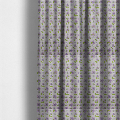 The fabric used to create these made-to-measure curtains is a light grey-purple fabric featuring a repeating pattern of purple and white flowers with green leaves.