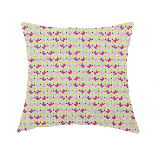 The fabric used to create this handmade cushion is a light green fabric featuring a dense, repeating pattern of small multi-coloured butterflies in pink, magenta, and purple, interspersed with tiny yellow flowers and dots.