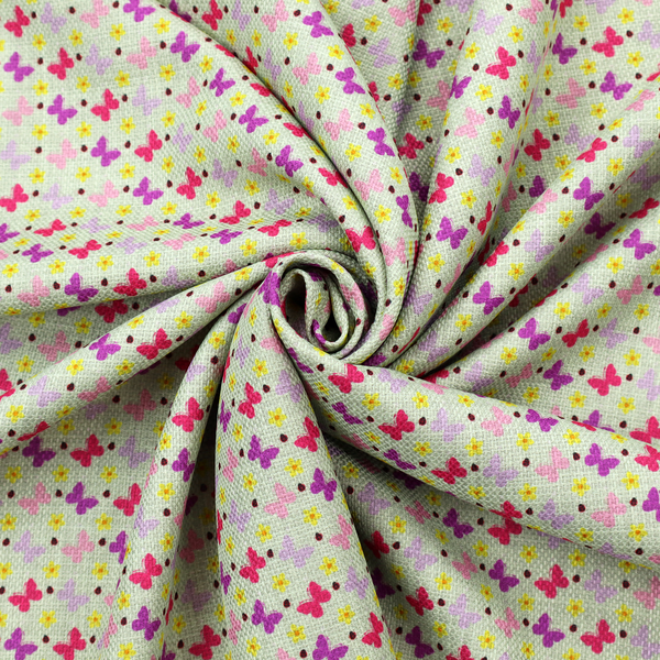 A light green fabric featuring a dense, repeating pattern of small multi-coloured butterflies in pink, magenta, and purple, interspersed with tiny yellow flowers and dots.