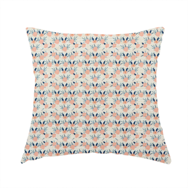 The fabric used to create this handmade cushion is an off-white fabric featuring a neat, repeating geometric pattern of small peach-pink flowers and dark blue leafy sprigs.