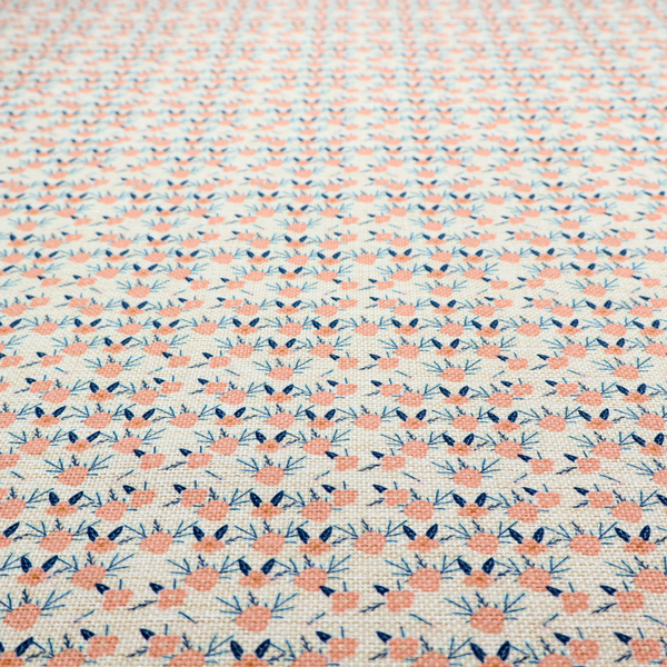 An off-white fabric featuring a neat, repeating geometric pattern of small peach-pink flowers and dark blue leafy sprigs.