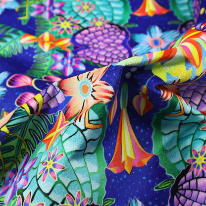 This fabric features an intricate, psychedelic-inspired tropical print with a rich, dark blue background.