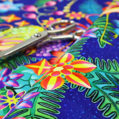 This fabric features an intricate, psychedelic-inspired tropical print with a rich, dark blue background.