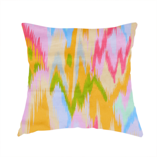 The fabric used to create this handmade cushions is a fabric features a vibrant, multi-coloured ikat-style pattern with a soft, blurred aesthetic.