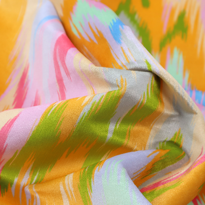 This fabric features a vibrant, multi-coloured ikat-style pattern with a soft, blurred aesthetic.