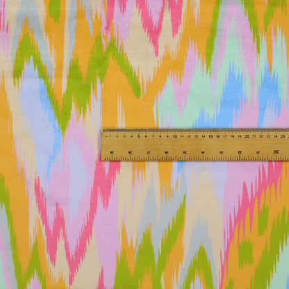 This fabric features a vibrant, multi-coloured ikat-style pattern with a soft, blurred aesthetic.