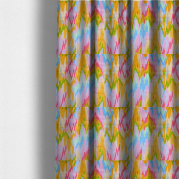 The fabric used to create these made-to-measure curtains is a fabric features a vibrant, multi-coloured ikat-style pattern with a soft, blurred aesthetic.