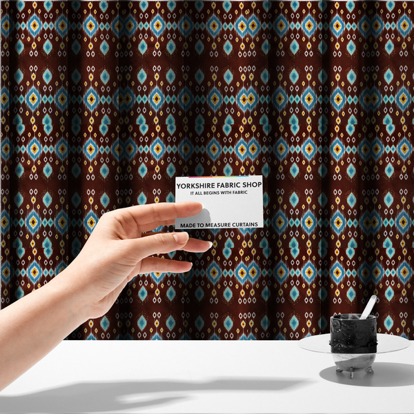 The fabric used to create these made-to-measure curtains is a fabric features a geometric, traditional-inspired ikat pattern set against a deep, rich chocolate-brown background.