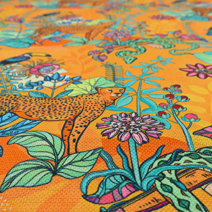 This vibrant, maximalist fabric features a stylized jungle motif set against a bold, warm orange background.