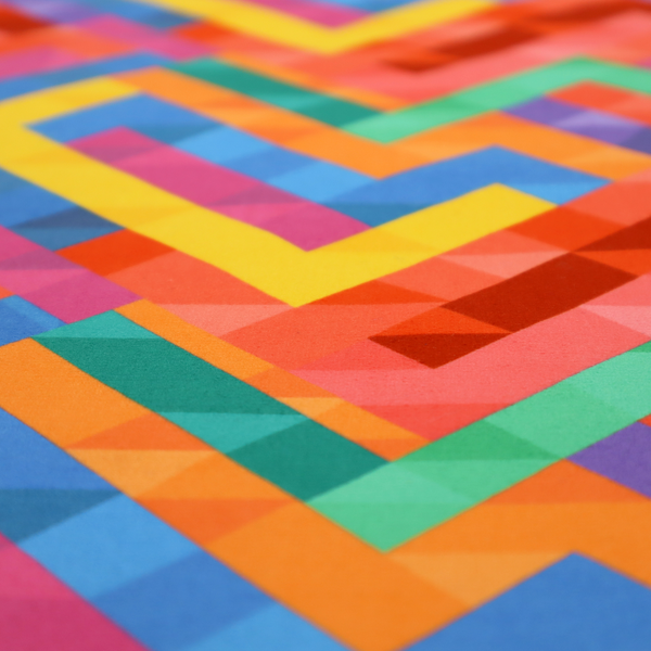 This fabric features a vibrant, geometric, and modular design that creates a dynamic, three-dimensional effect.