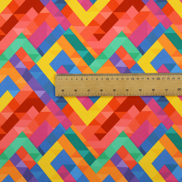 This fabric features a vibrant, geometric, and modular design that creates a dynamic, three-dimensional effect.