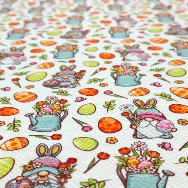 This fabric features a playful and detailed Easter garden pattern set against a crisp, white background. The design is a bright and busy "tossed" print that combines the popular gnome trend with traditional spring motifs.