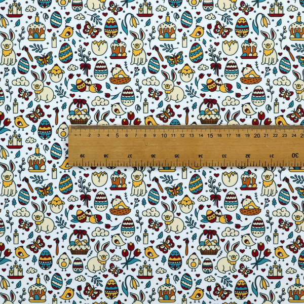 This fabric features a whimsical, hand-drawn Easter doodle pattern set against a clean, pale blue-grey background. The design is a dense, "scatter" style print using a primary colour palette of deep red, mustard yellow, and teal blue.