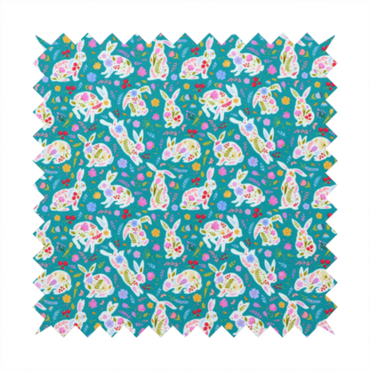 This fabric features a vibrant, folk-art inspired Easter pattern set against a rich teal-green background. The design is characterized by its high-contrast colour palette and intricate floral silhouettes.